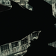 Batman flying across the Gotham skyline in Batman: Damned.